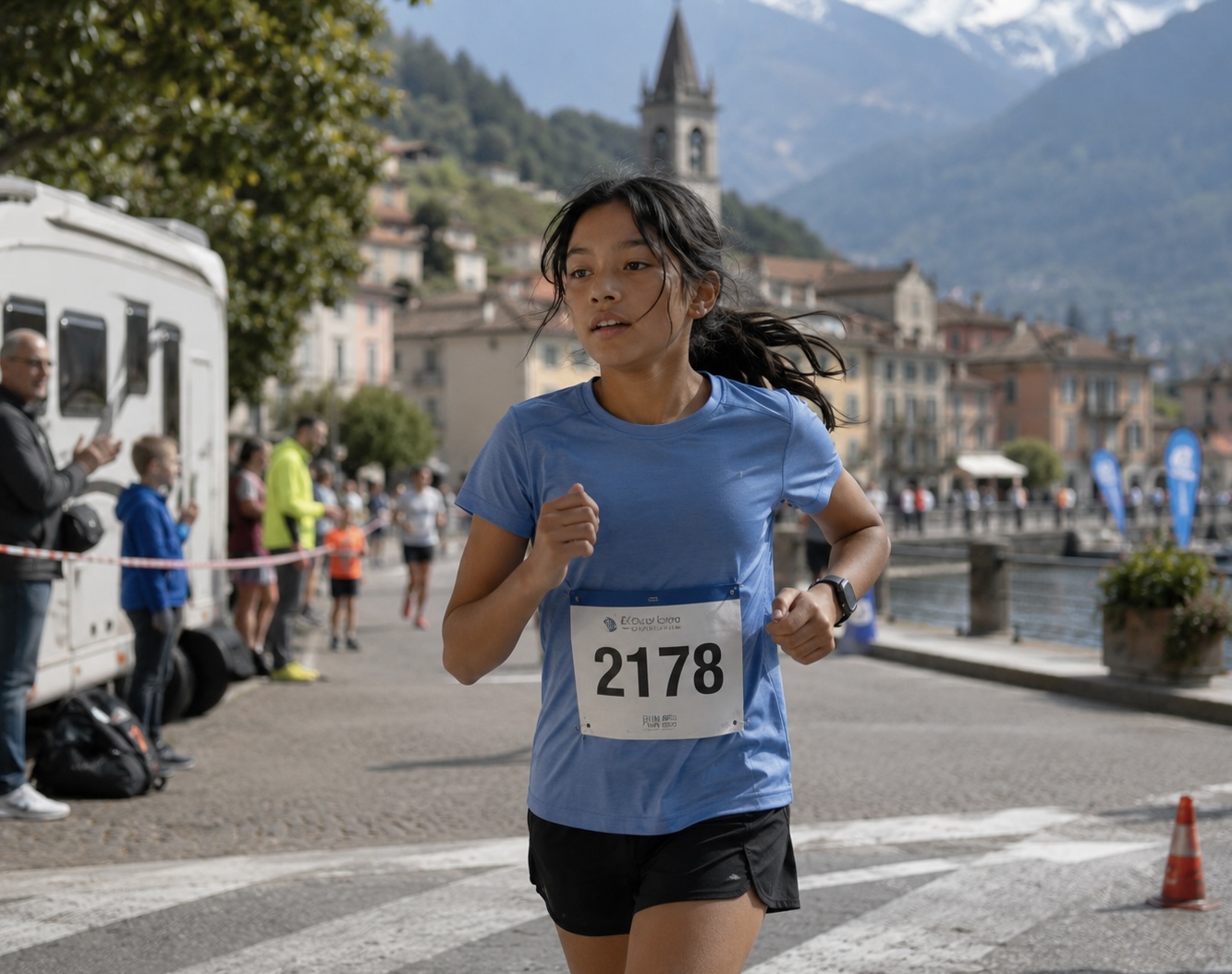 A young runner competing beside a European lakeside town.